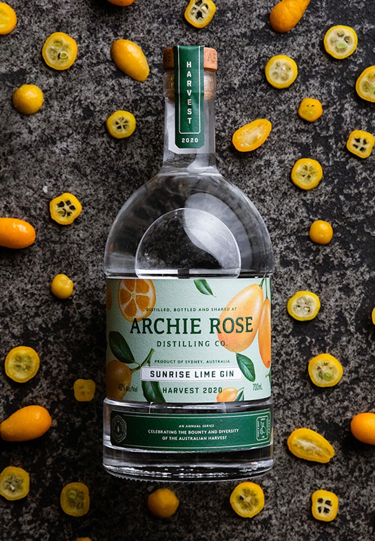overhead-shot-of-archie-rose-sunrise-lime-gin-harvest-2020-surrounded-by-fresh-sunrise-limes