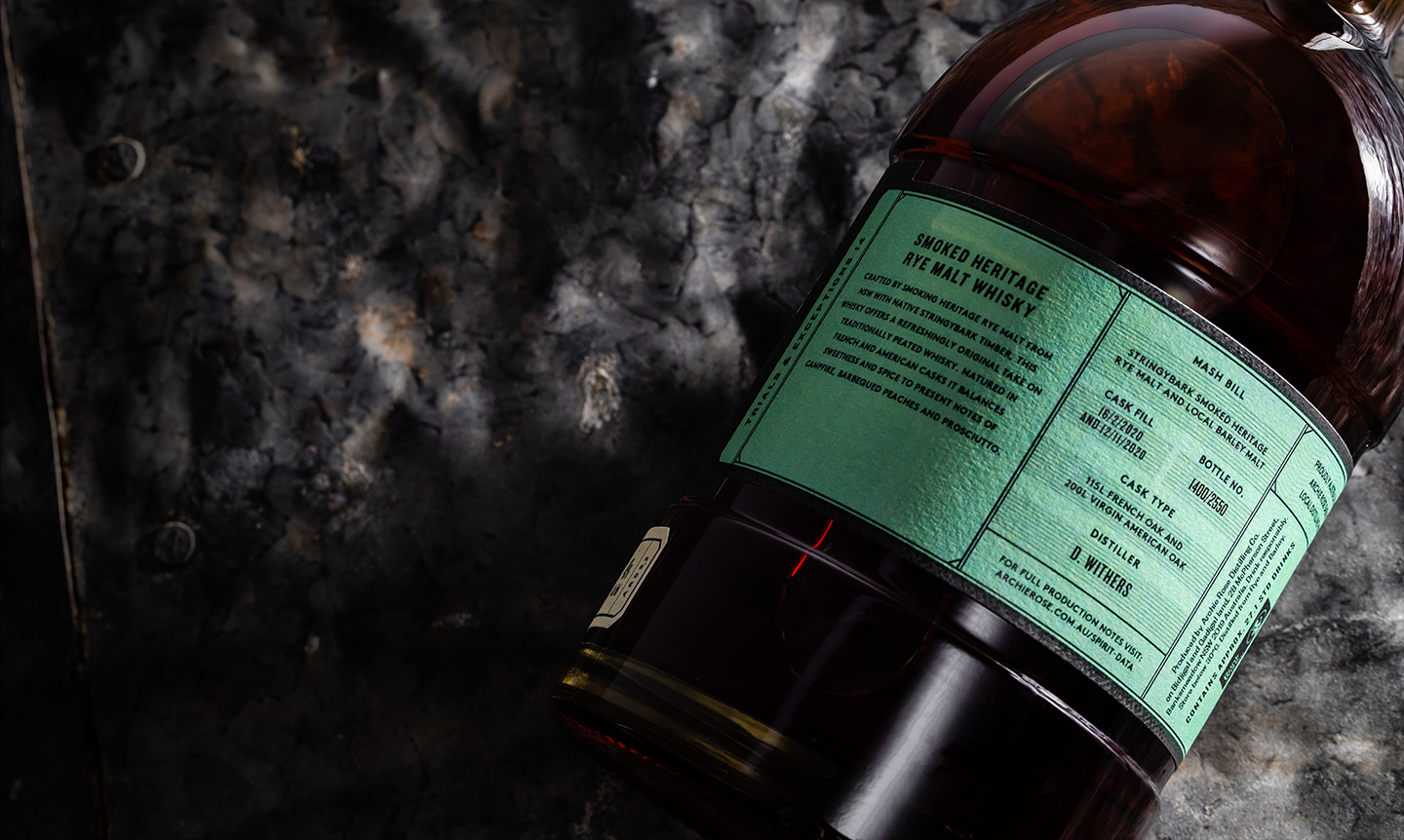 Overhead-view-of-back-of-Archie-Rose-Smoked-Heritage-Rye-Malt-Whisky-bottle