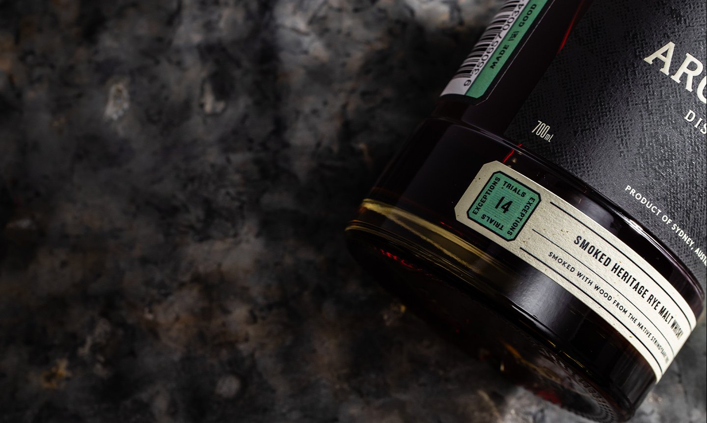 Overhead-view-of-Archie-Rose-Smoked-Heritage-Rye-Malt-Whisky-bottle-base-label