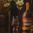 Thumbnail for archie-rose-dry-grown-rye-malt-whisky-front-on-full-bottle-shot-on-table-with-glencairn-whisky-glass-and-flowers-and-green-apples