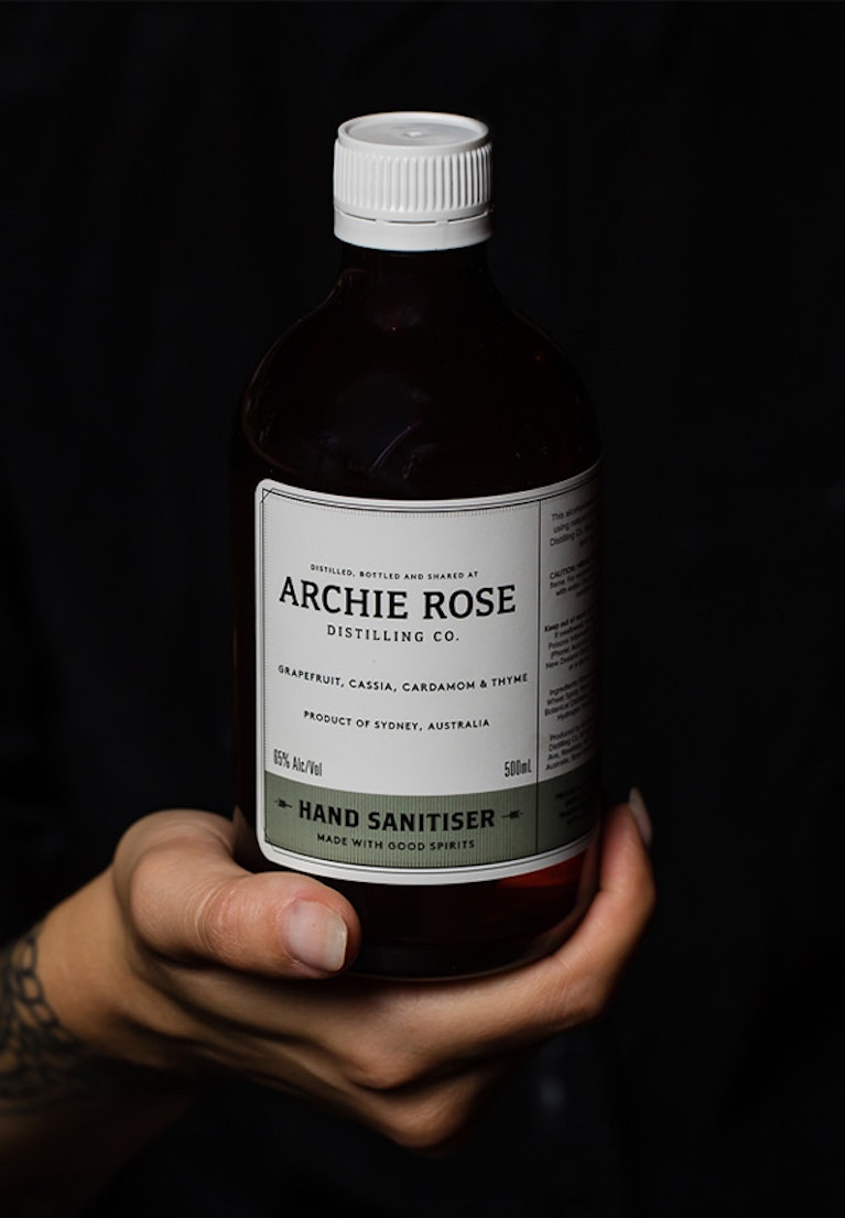 Hand-holding-bottle-of-Archie-Rose-Hand-Sanitiser