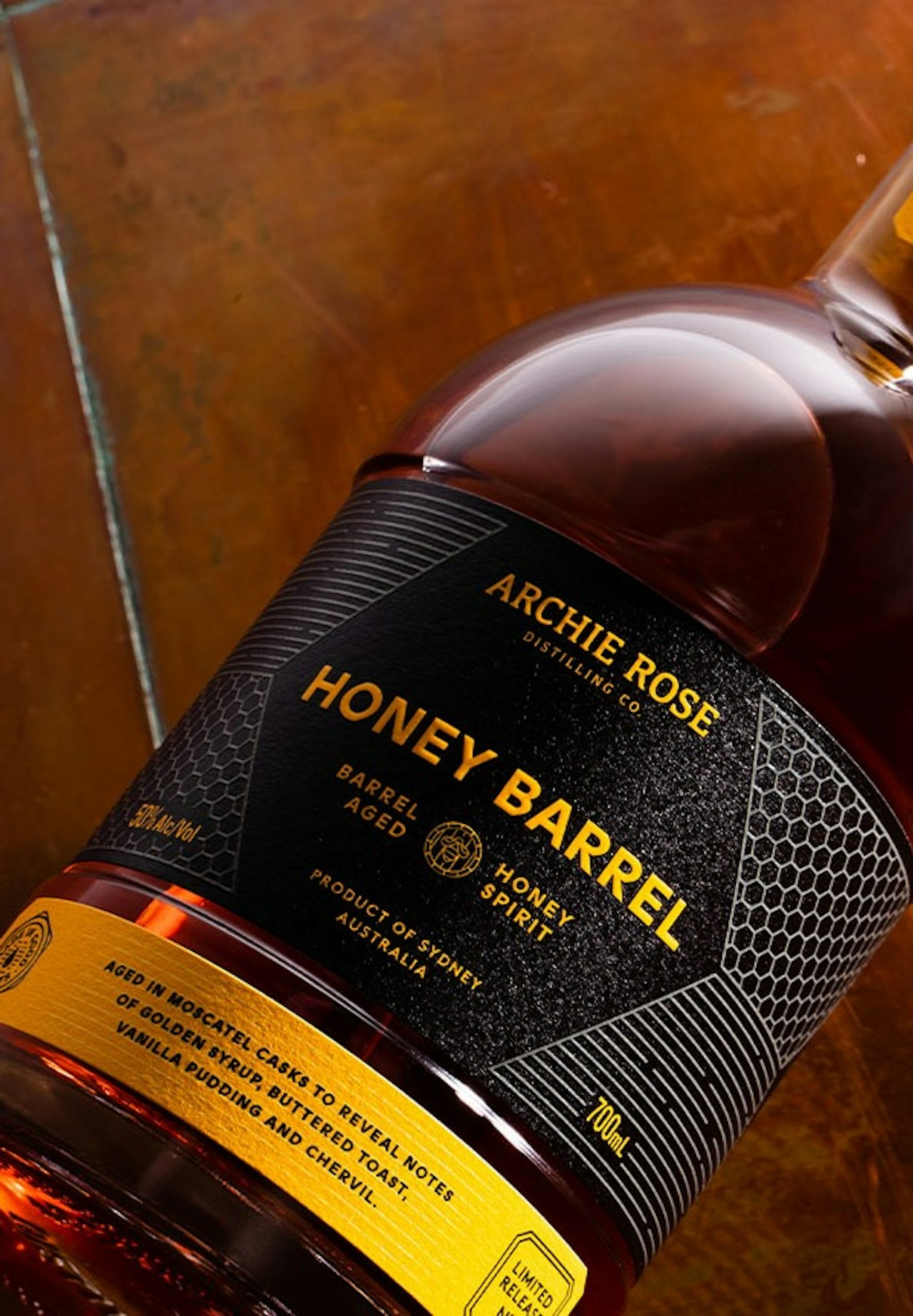archie-rose-honey-barrel-barrel-aged-honey-spirit-overhead-shot-front-of-bottle