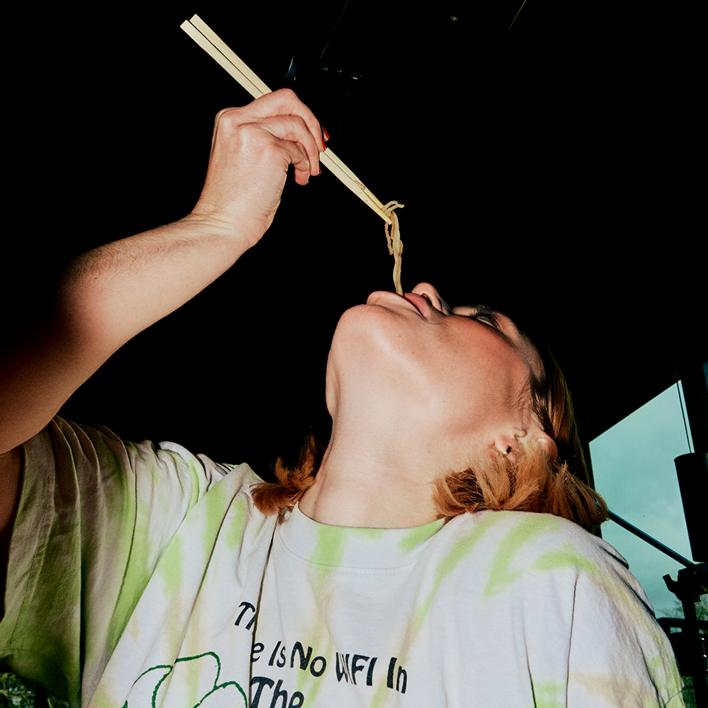 girl eating noodles with chopsticks