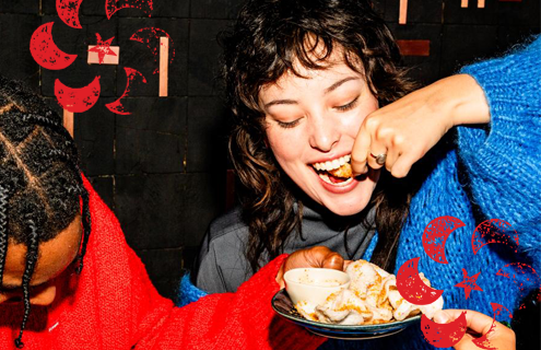 a girl eats koko prawn crackers