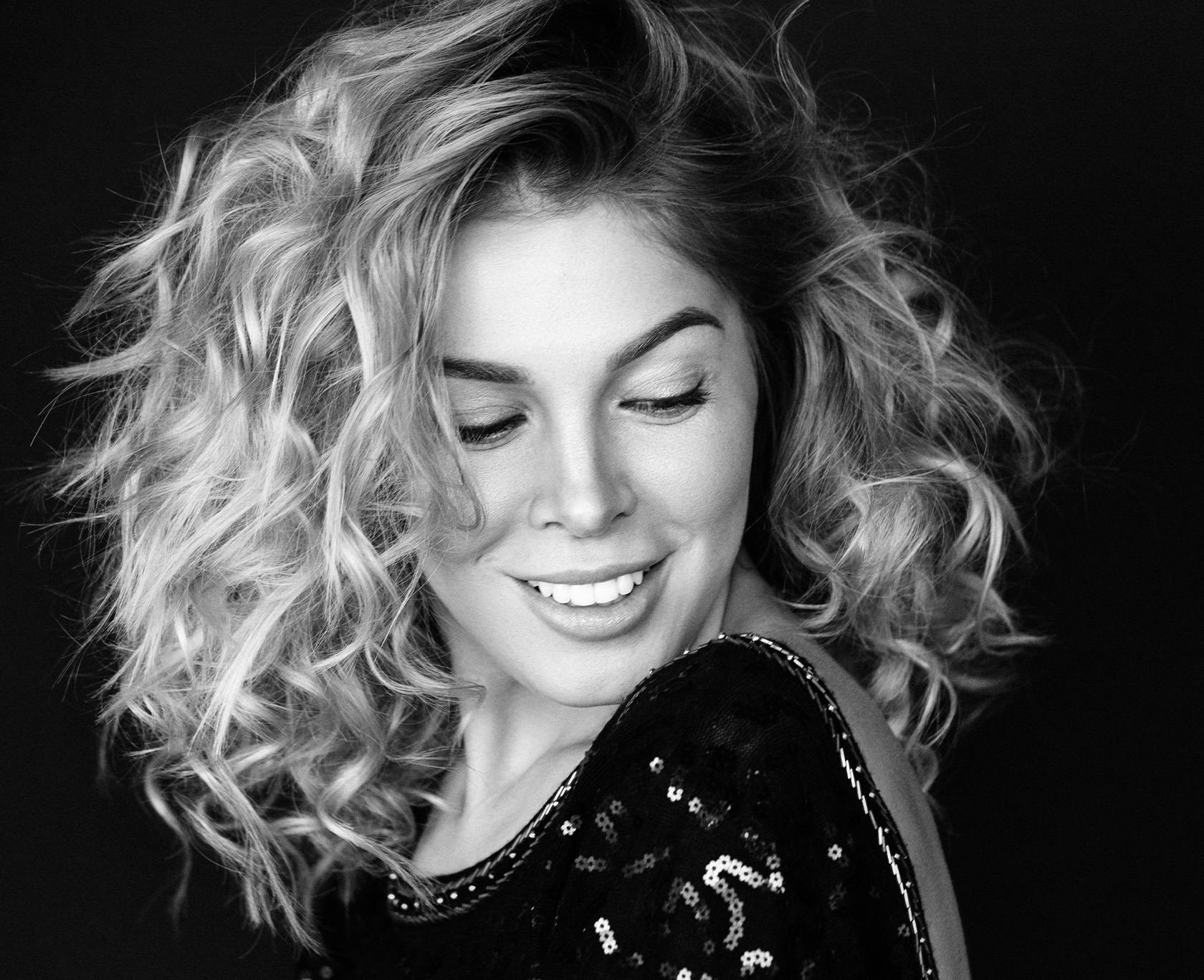 Black and white photo of woman wearing a sparkly top