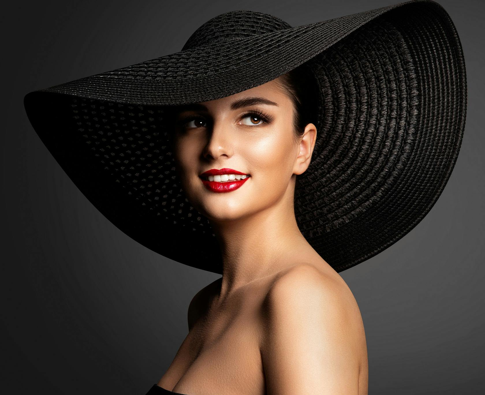 Woman in a black sun hat smiling
