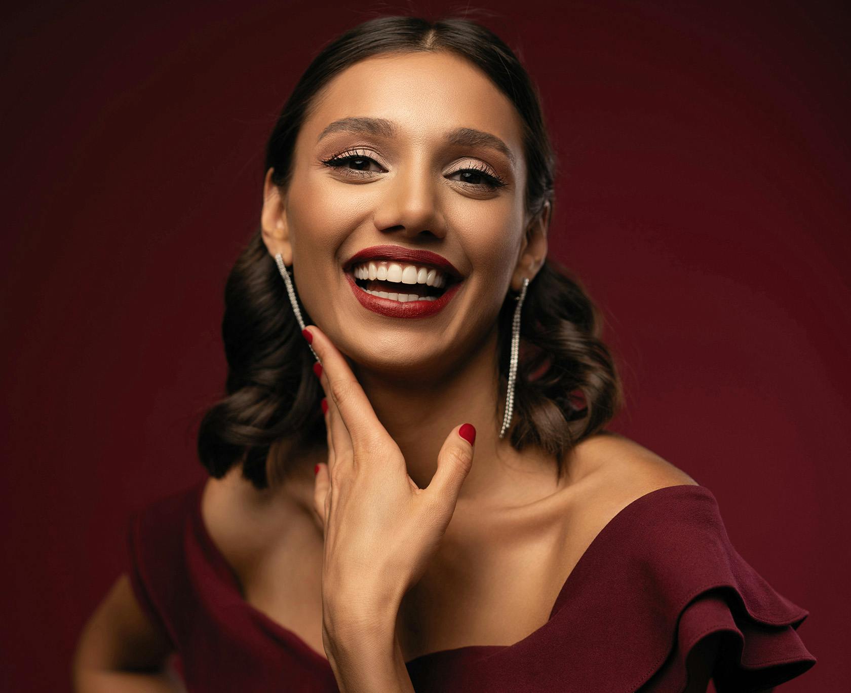 Woman in maroon dress smiling