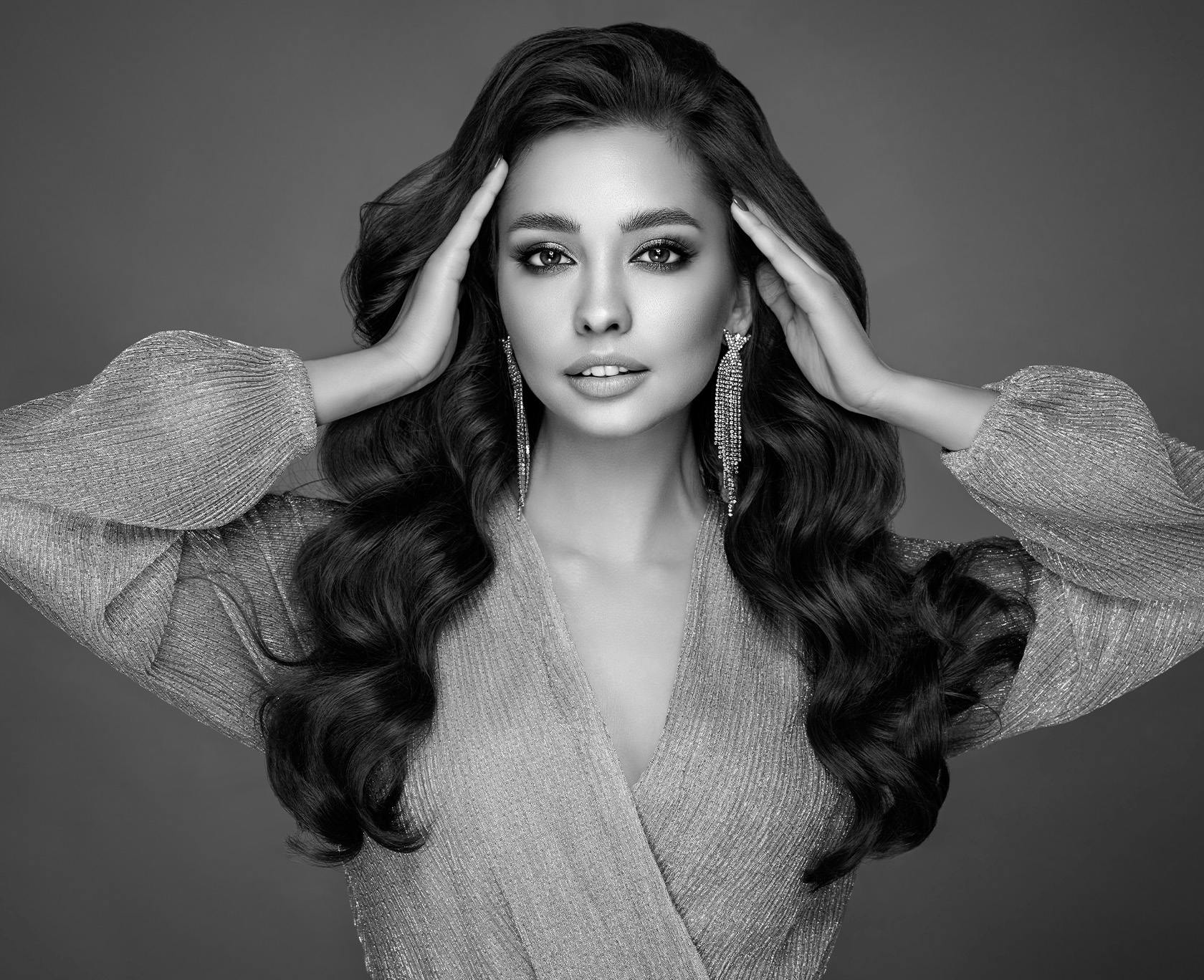 Black and white photo of woman with sparkly earrings