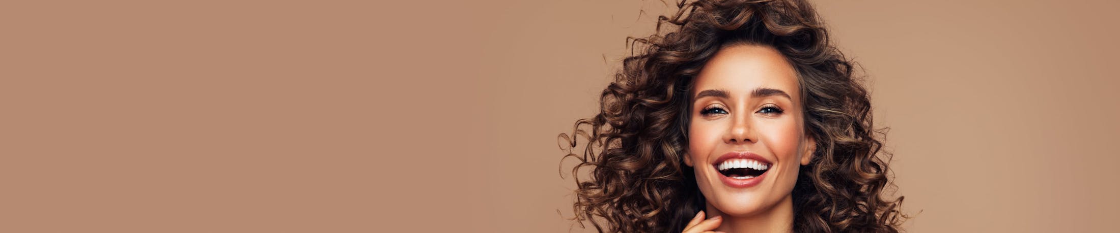 Woman with curly hair smiling