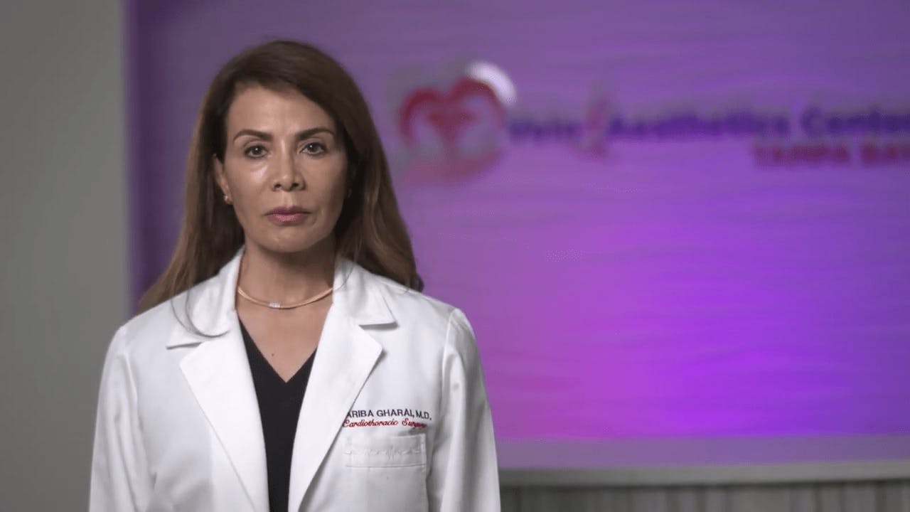 Dr. Fariba Gharai in a lab coat at her front desk