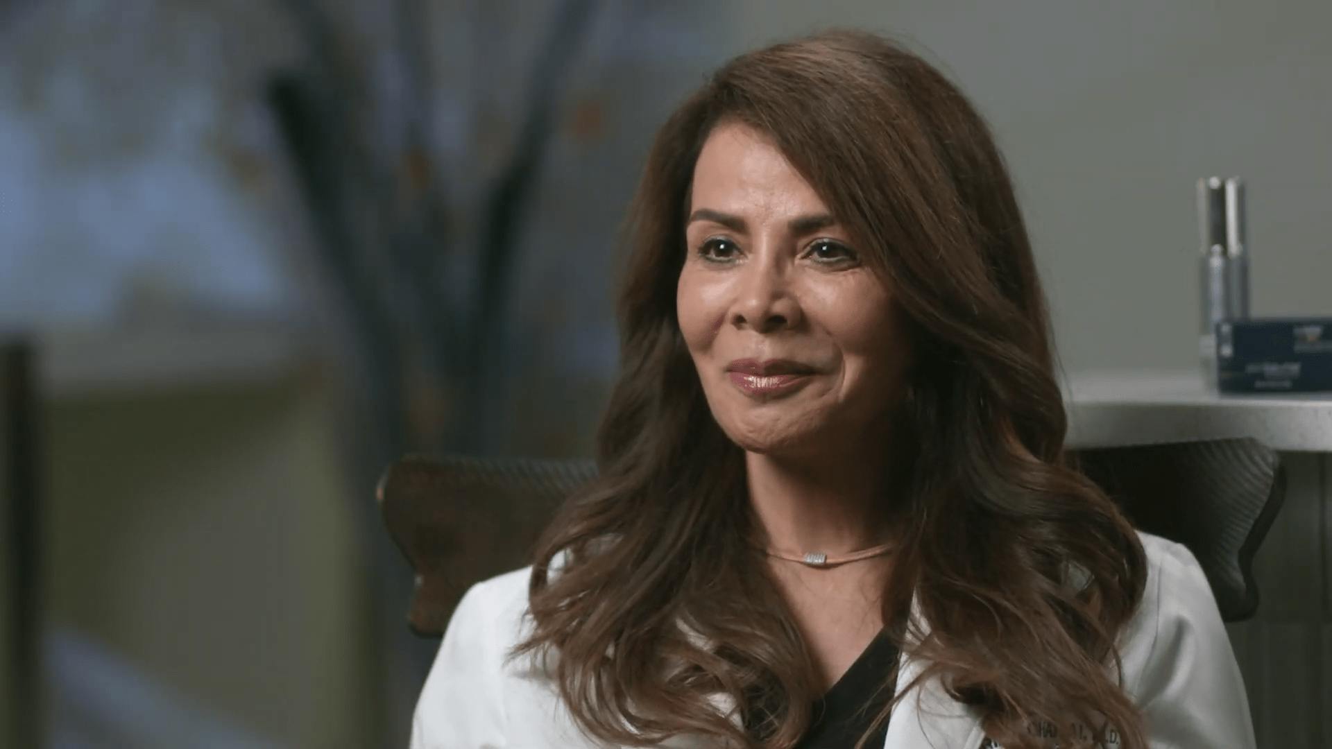 Dr. Gharai sitting down with a suit on