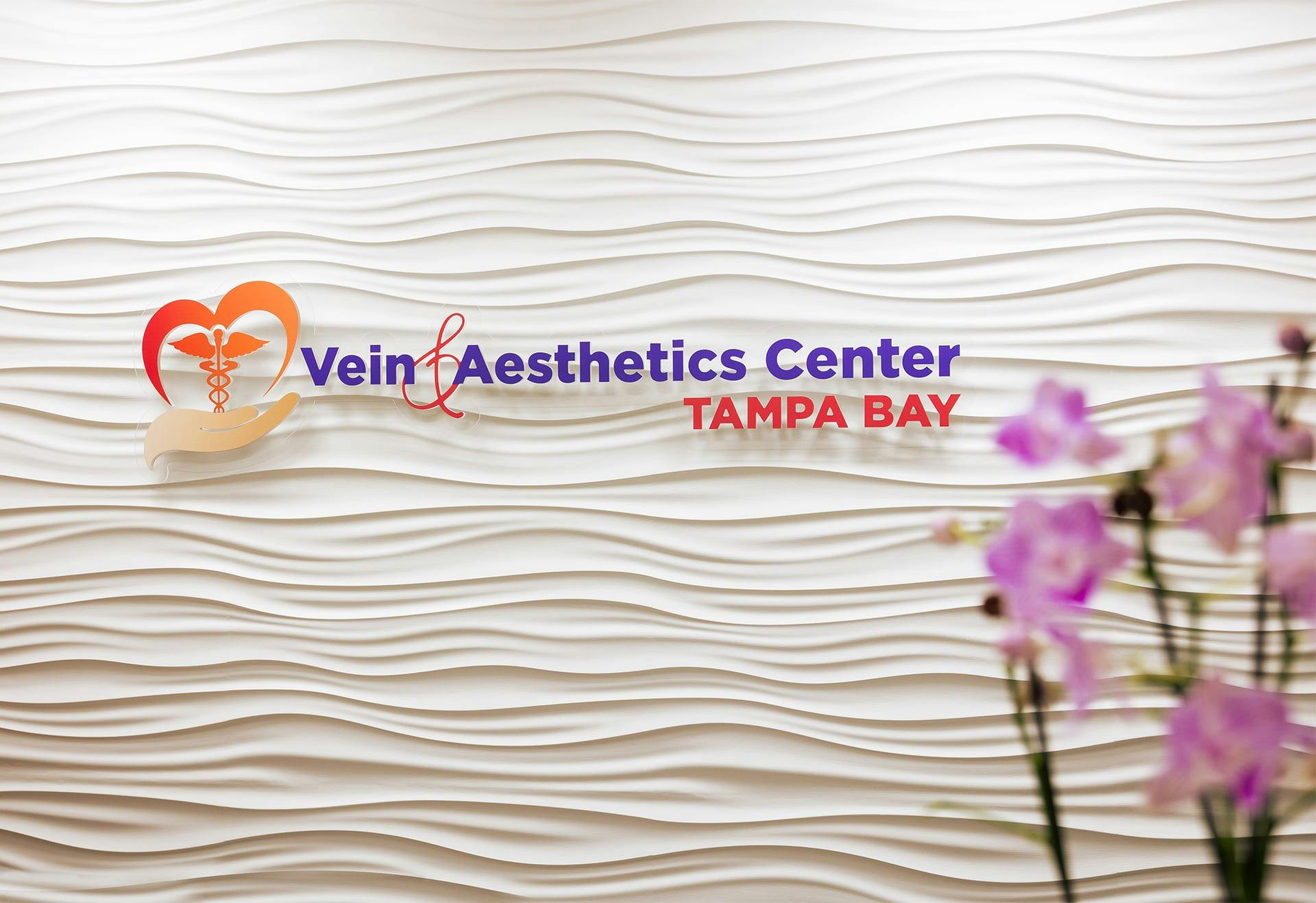 Vein & Aesthetics Center sign with flowers in front