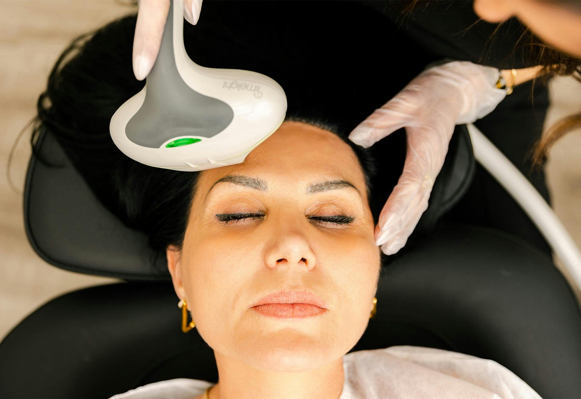 Woman getting a facial treatment while lying down