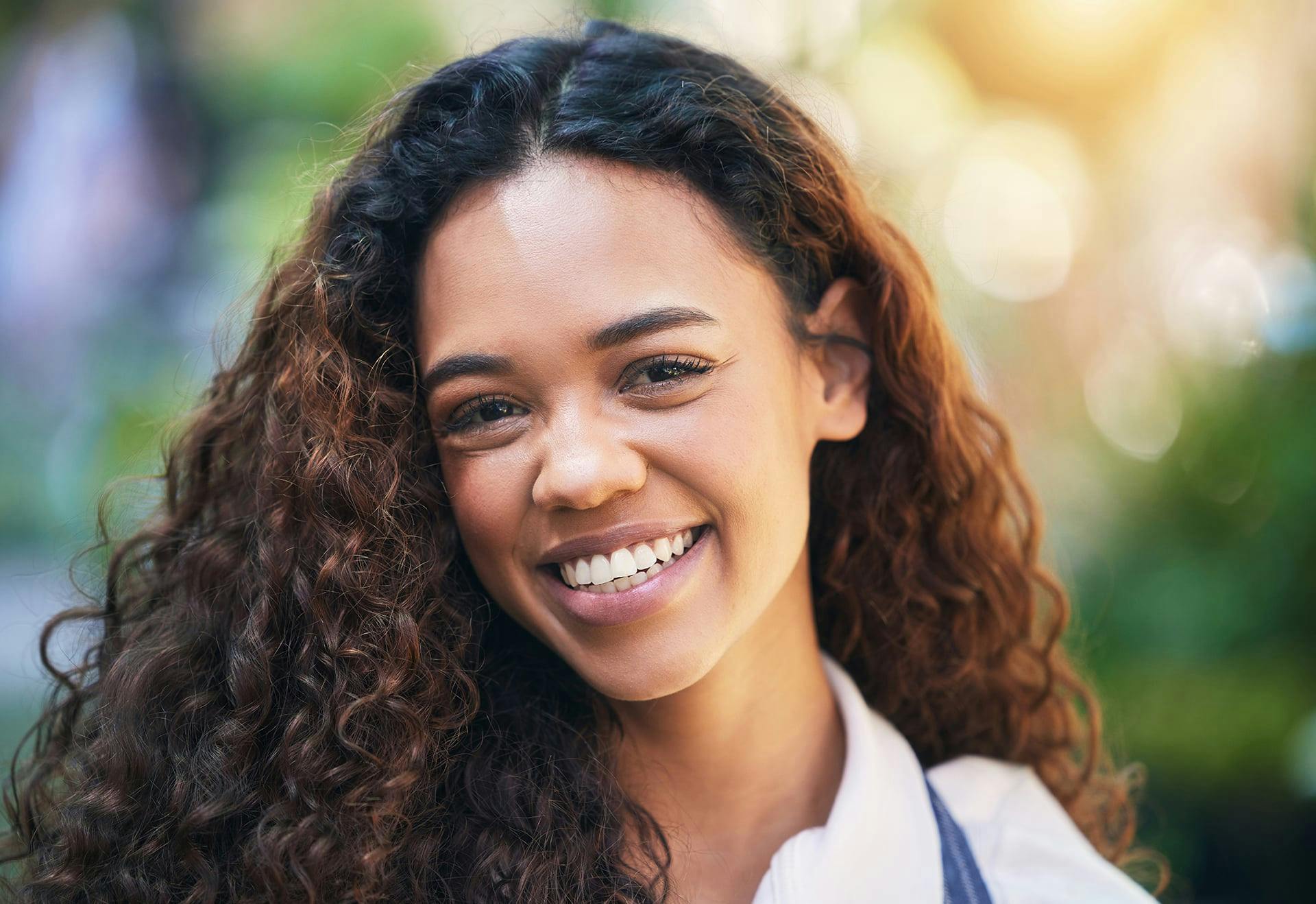 Close-up of a woman with dark, curly hair