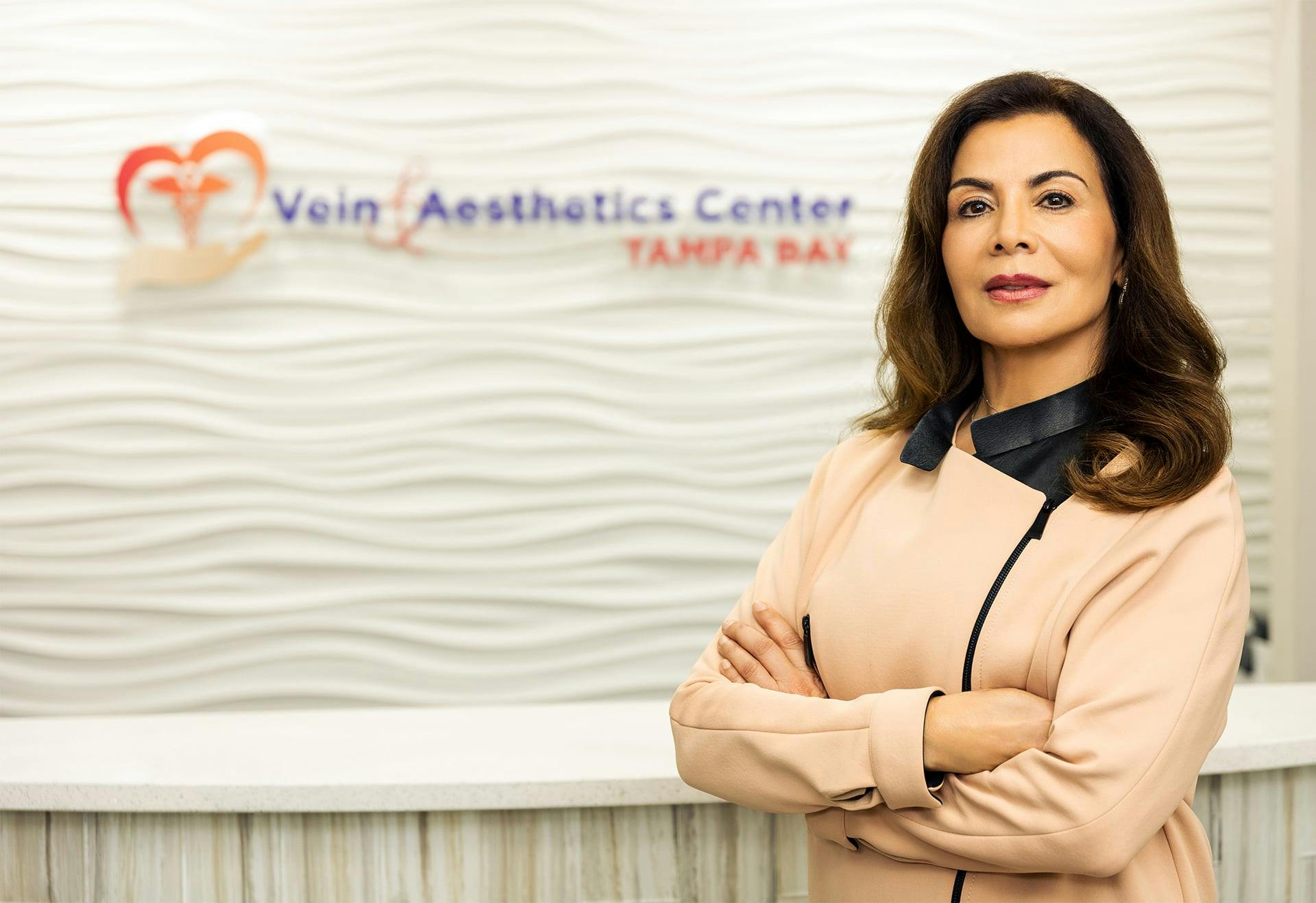 Dr. Fariba Gharai standing at the front desk of her office