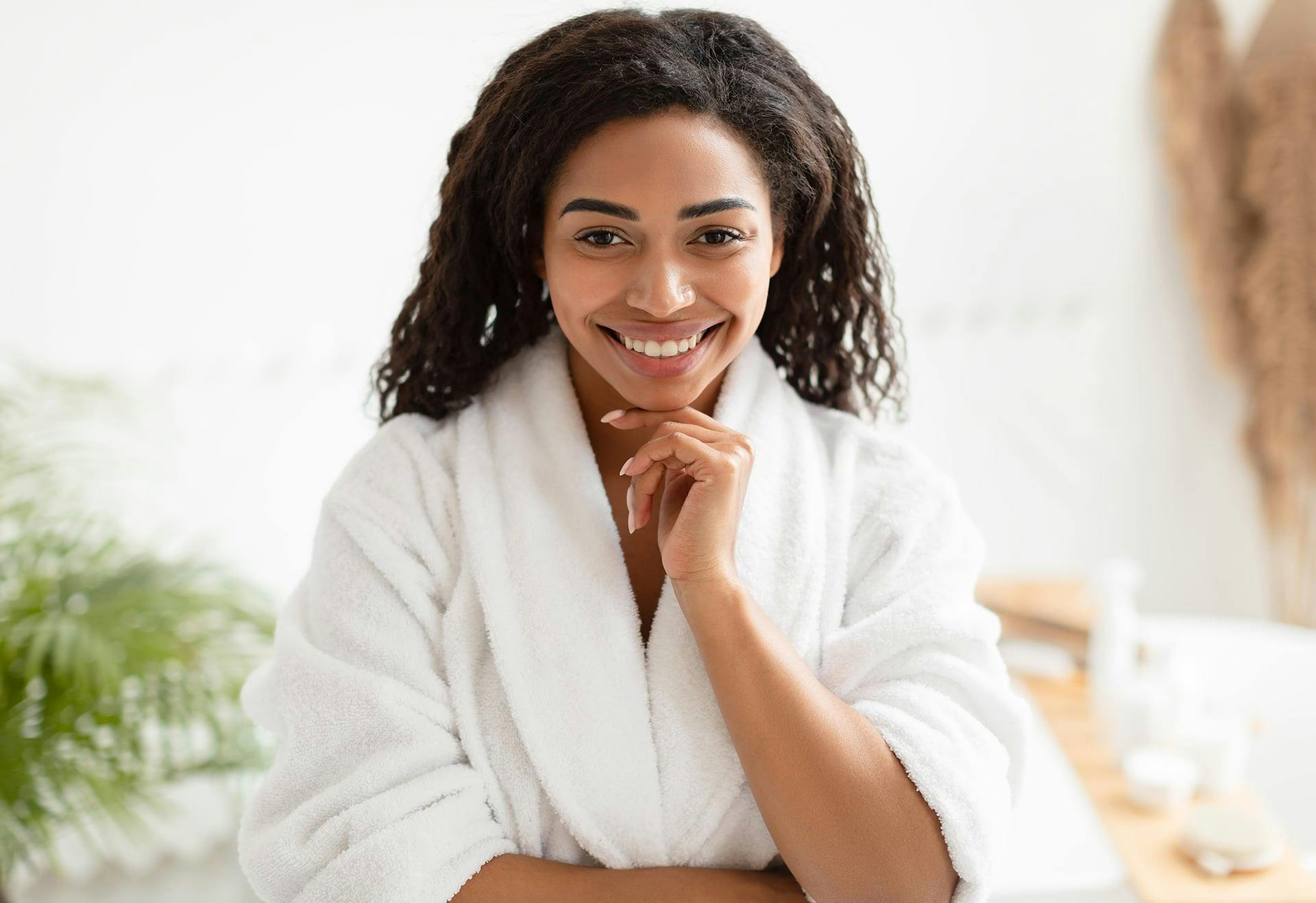 Woman in a robe and a hand against her chin