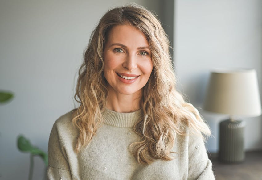 Woman with curly hair, smiling