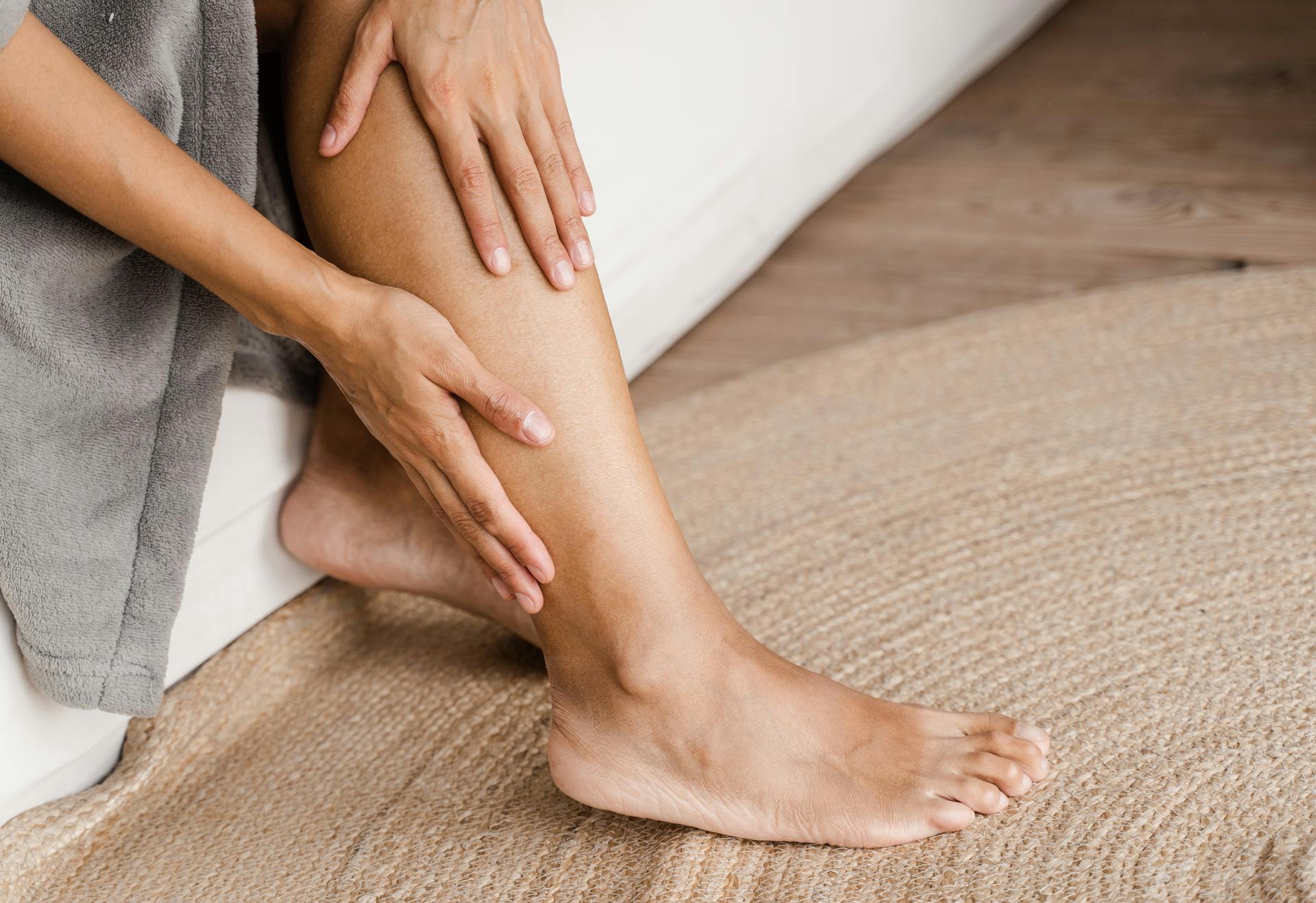 Person with both hands against a leg