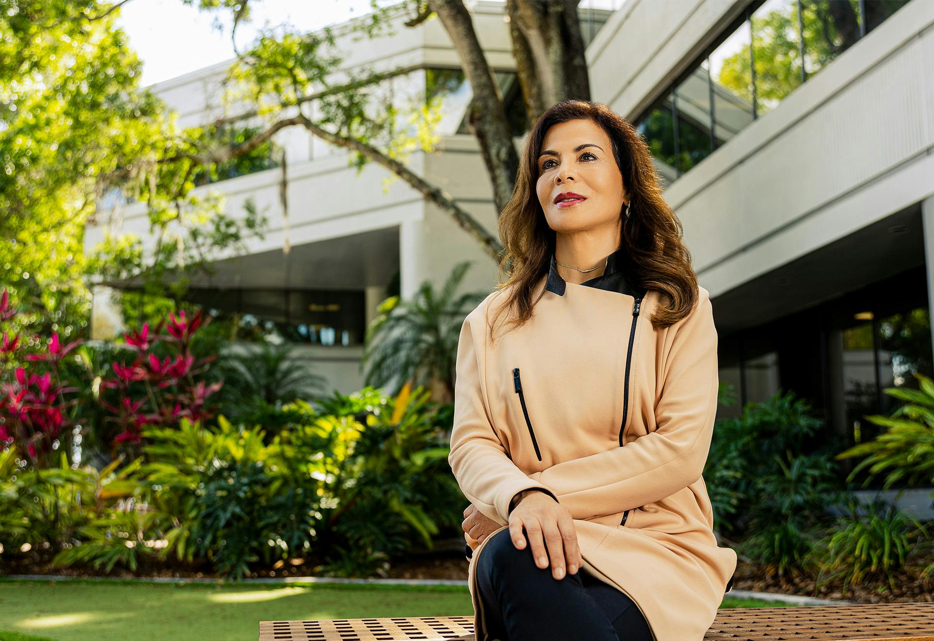 Dr. Gharai sitting outside on a bench