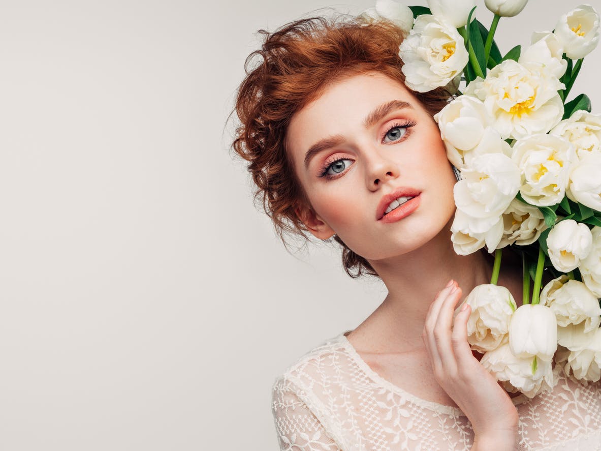 Woman standing with white roses