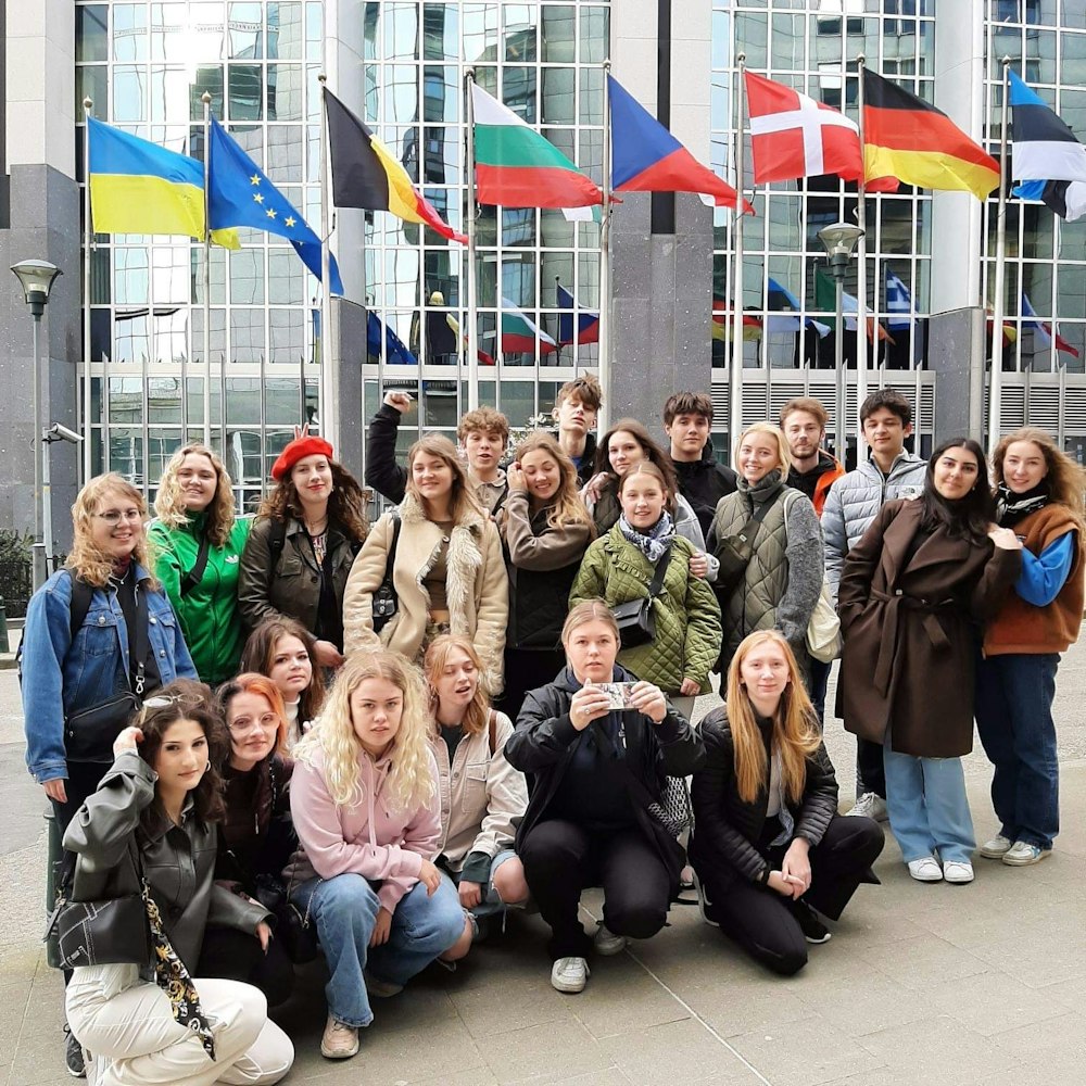 Klassebillede af sproglig klasse foran europæsiske flag på studietur i  Bruxelles