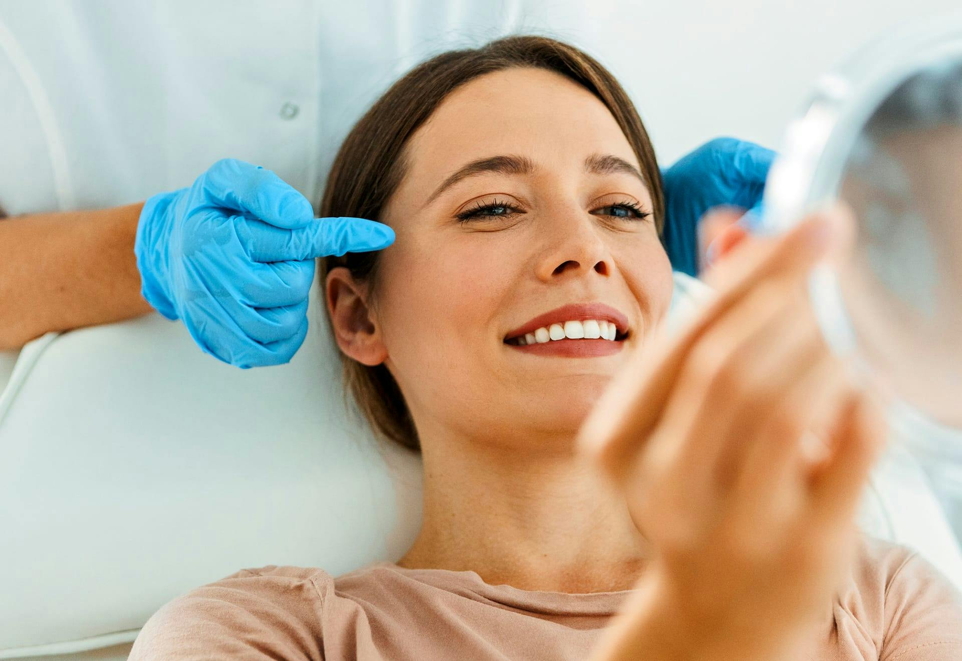 Woman getting her face examined
