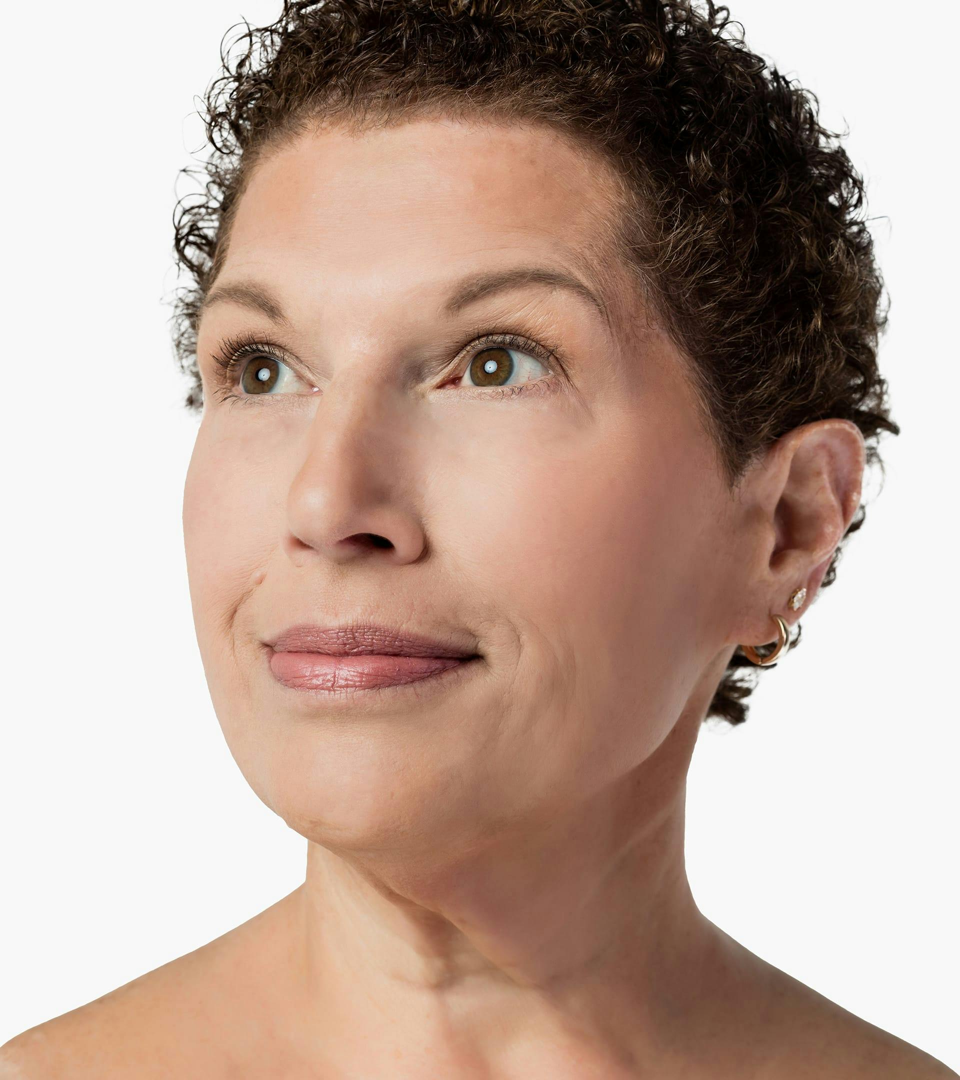close up of a woman's face with a short hair and a necklace on