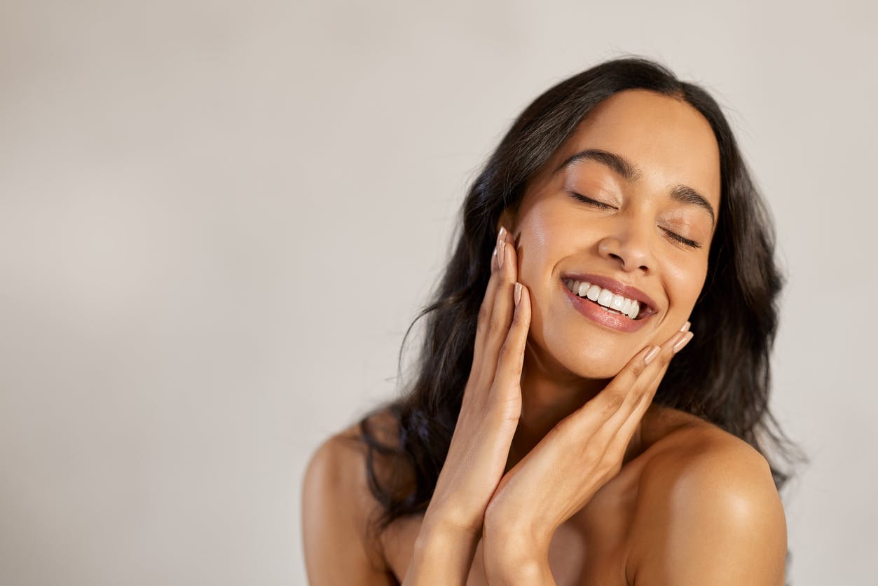 Woman smiling and holding chin