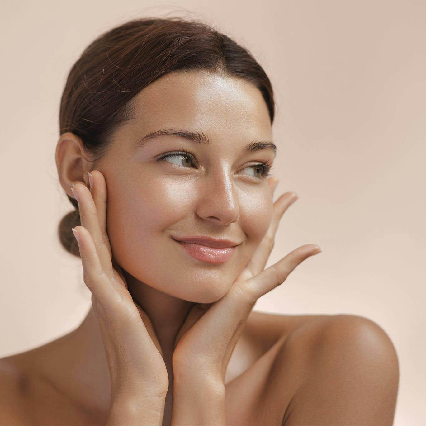 Woman smiling and holding cheeks