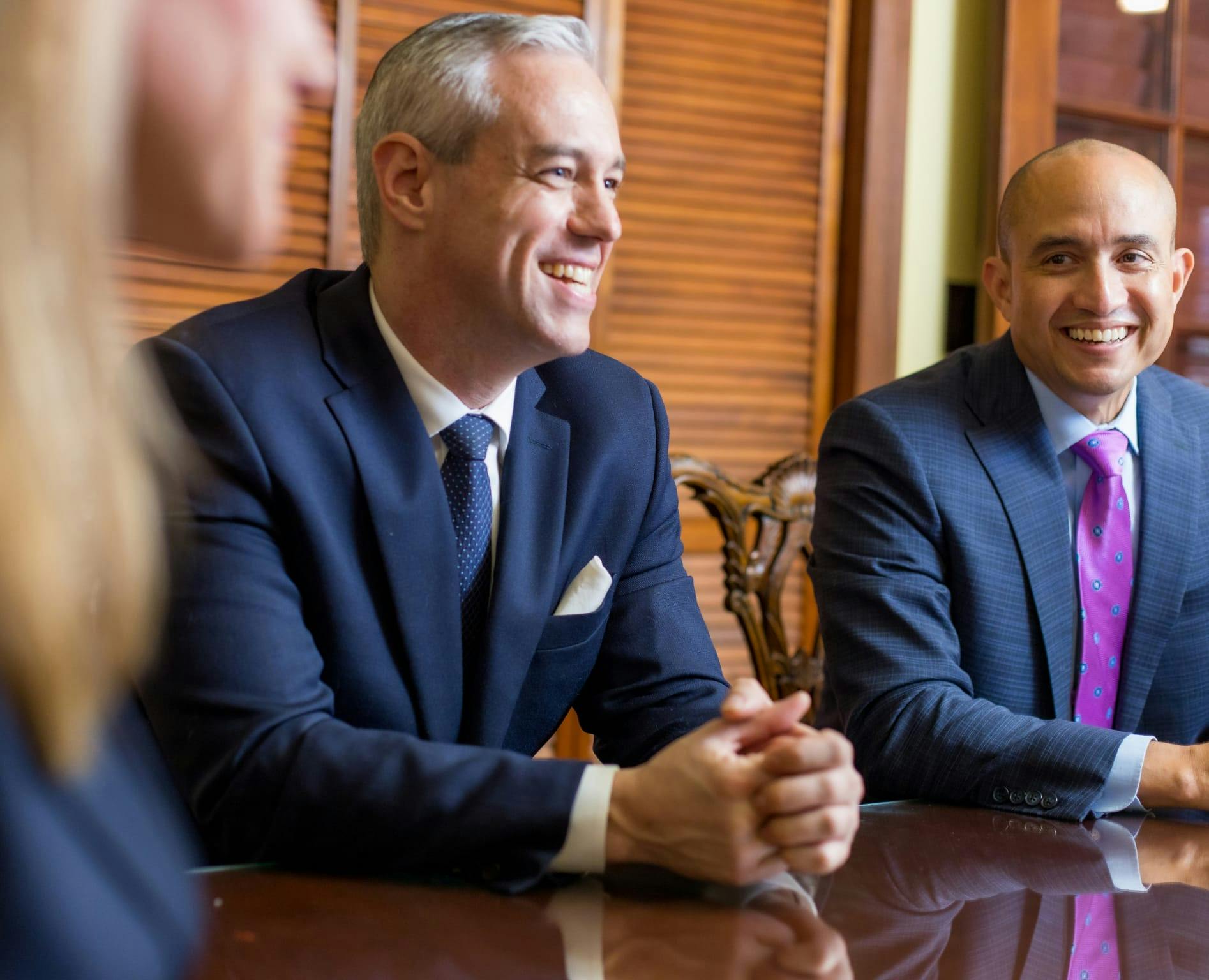 Carlson, Meissner & Hayslett P.A. attorneys sitting at a table