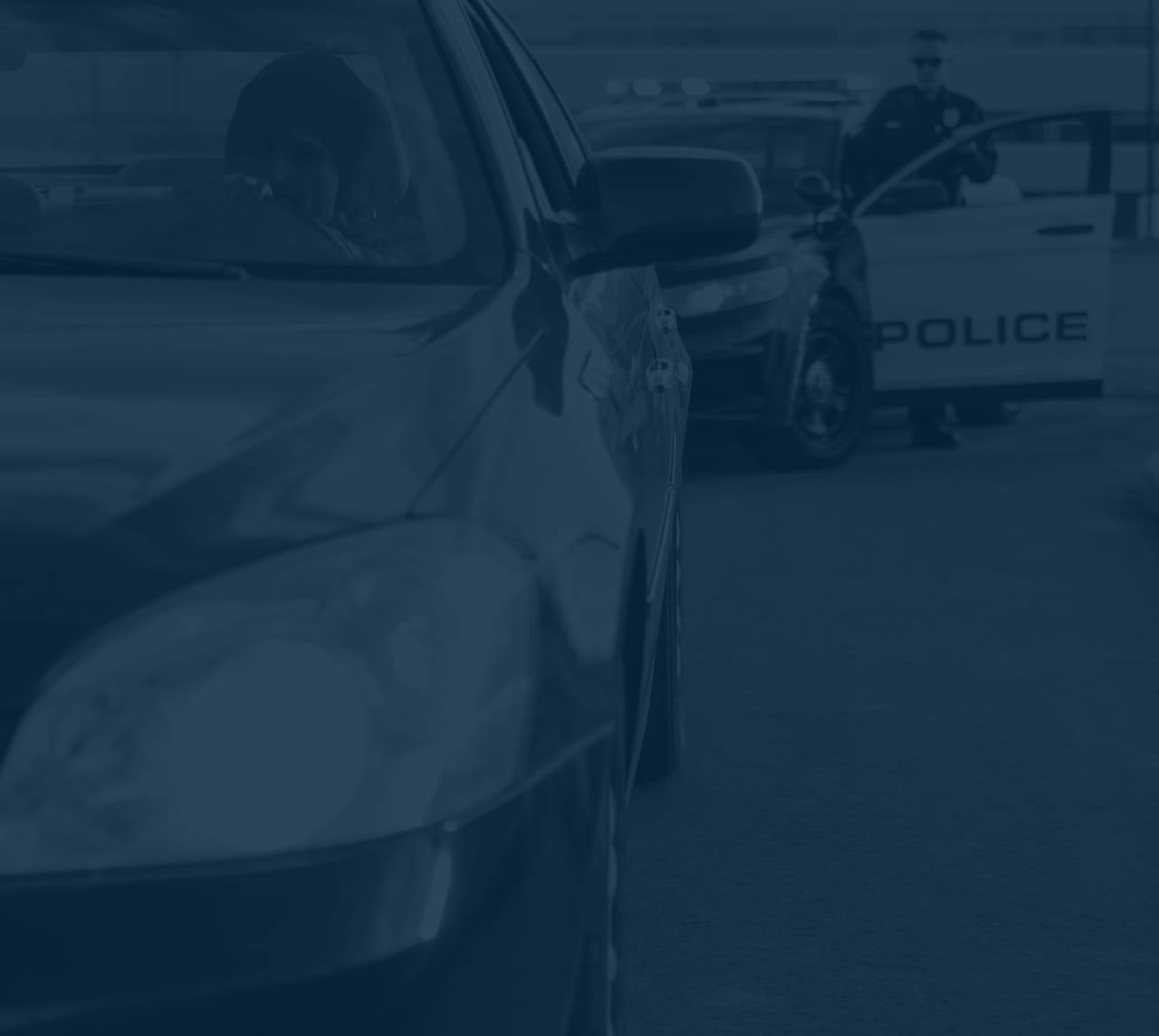 Person getting pulled over, image has a blue filter over it