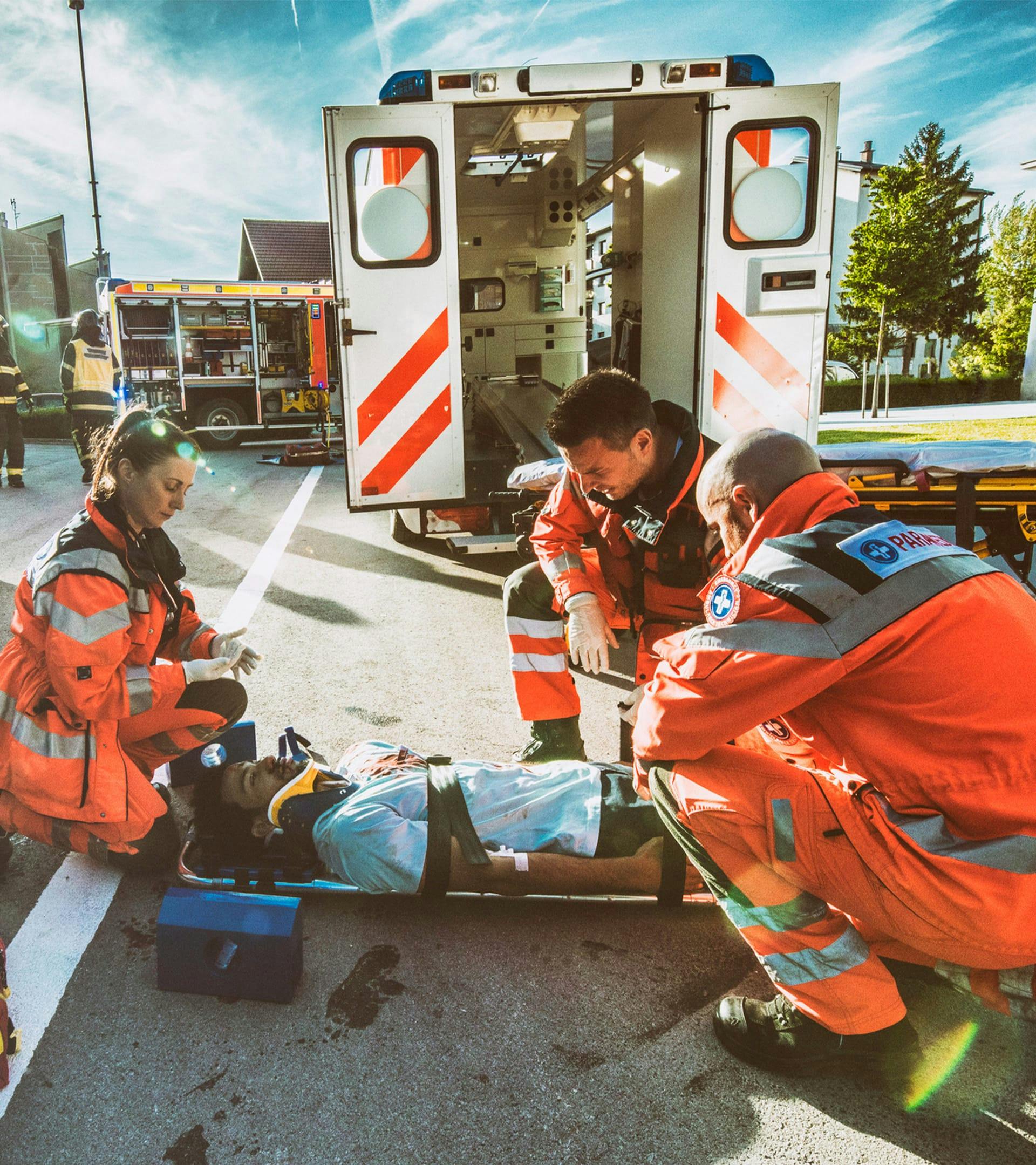 Paramedics helping an injured person.