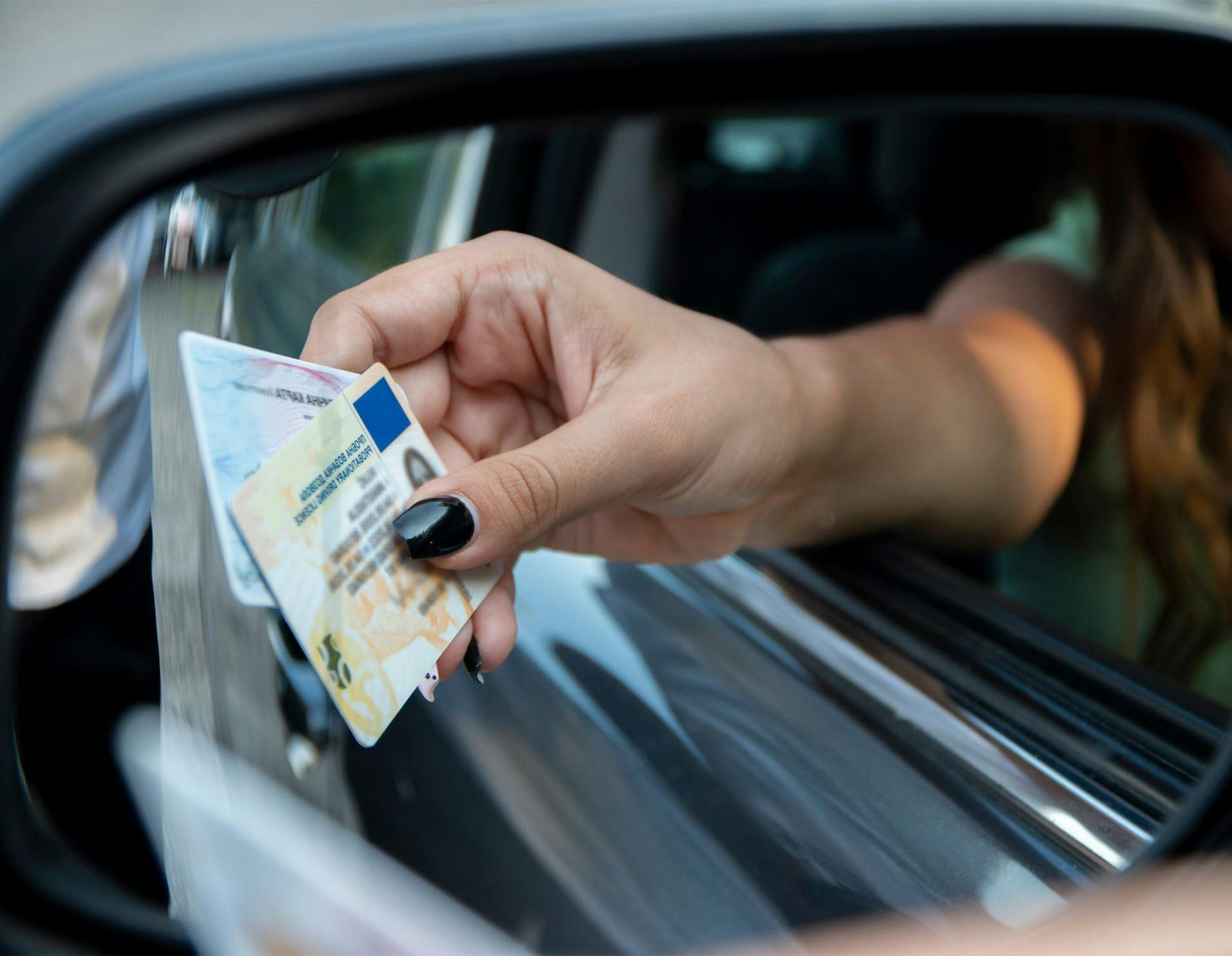 Woman driver handing license and registration