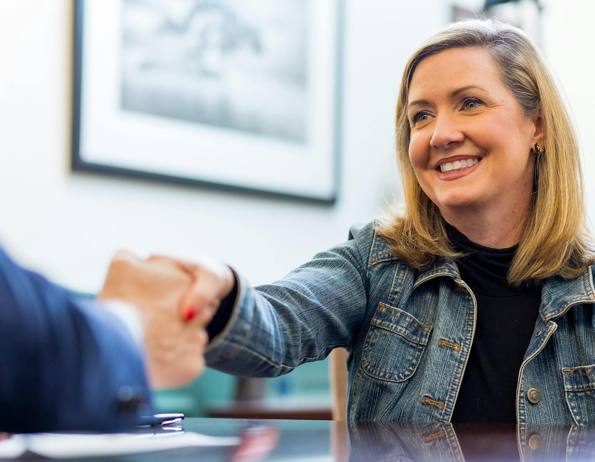 Attorney shaking client's hand
