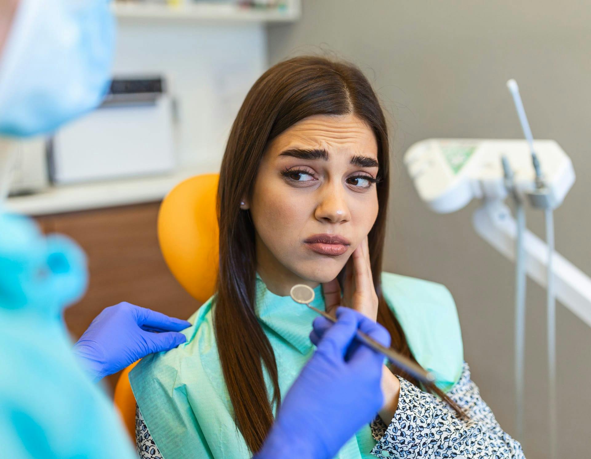 Woman in dental office in pain