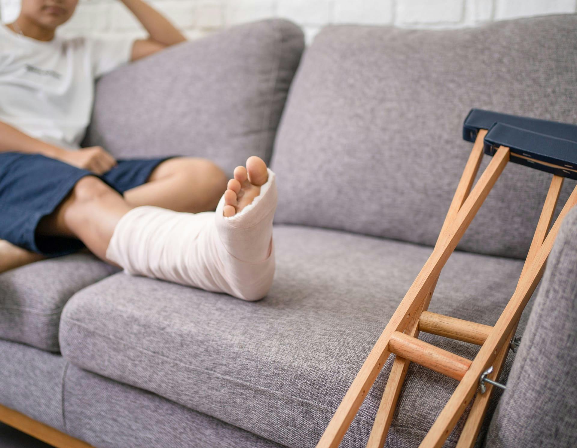 Person in cast sitting on couch