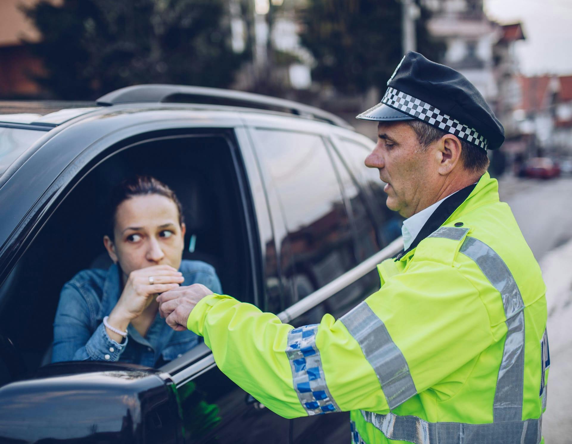 Officer conducting breathalizer on driver