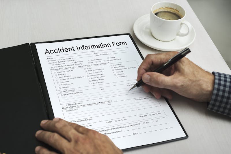 Person filling out accident information form.