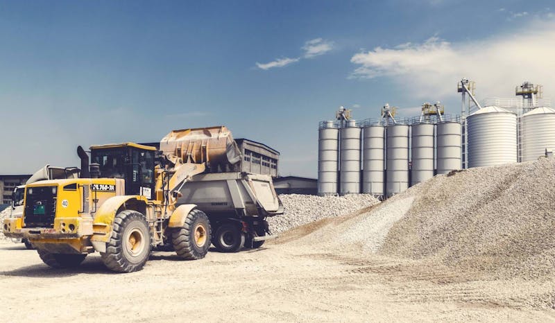 Dump truck being loaded on a job site.