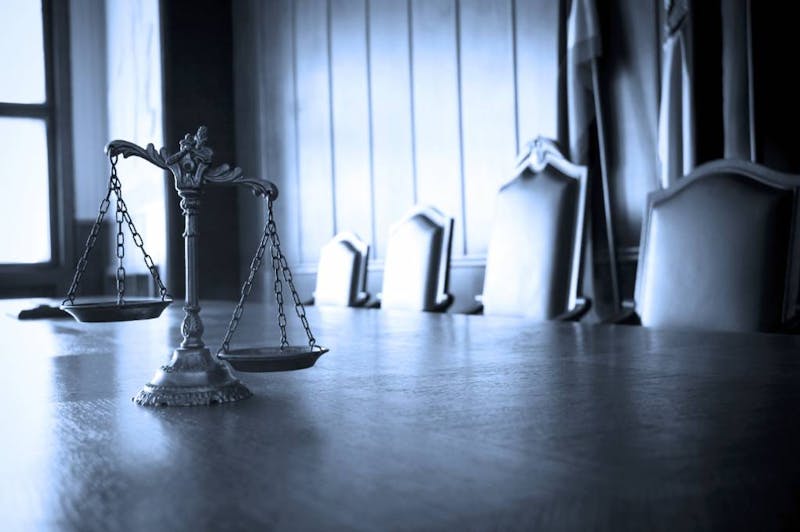 Scales of justice on a big, empty table.