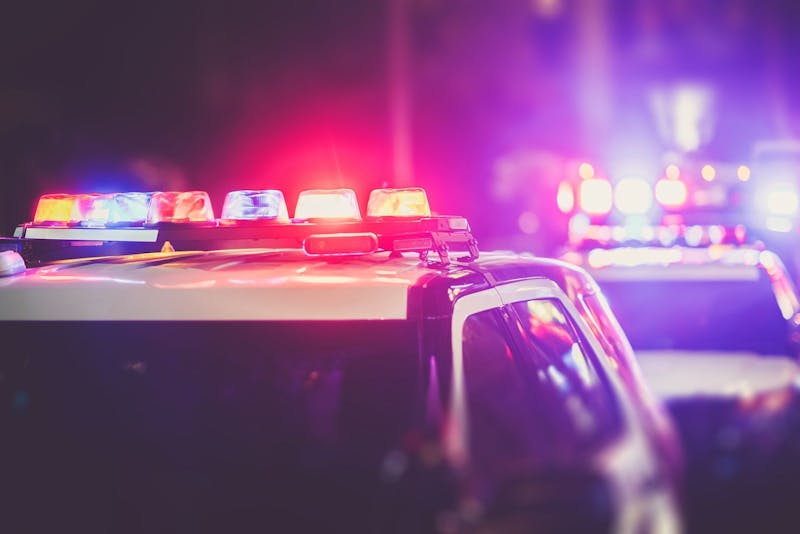 Police cars lit up at night.