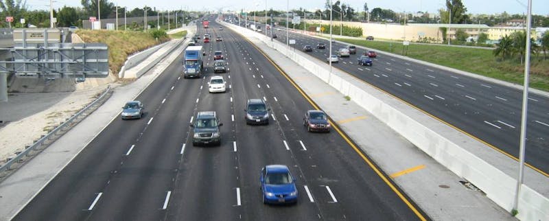 Overhead shot of a freeway with cars on it.