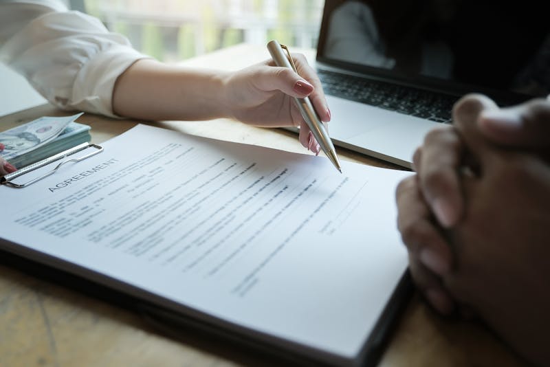 Two people working over a contract.