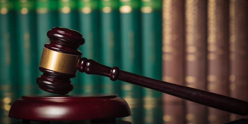 Gavel in front of a bookshelf.