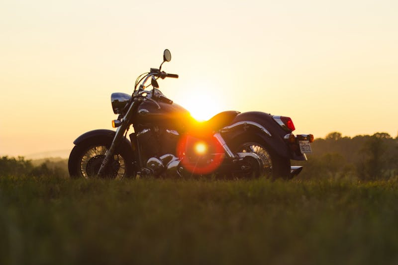 Motorcycle with the sun in the background.