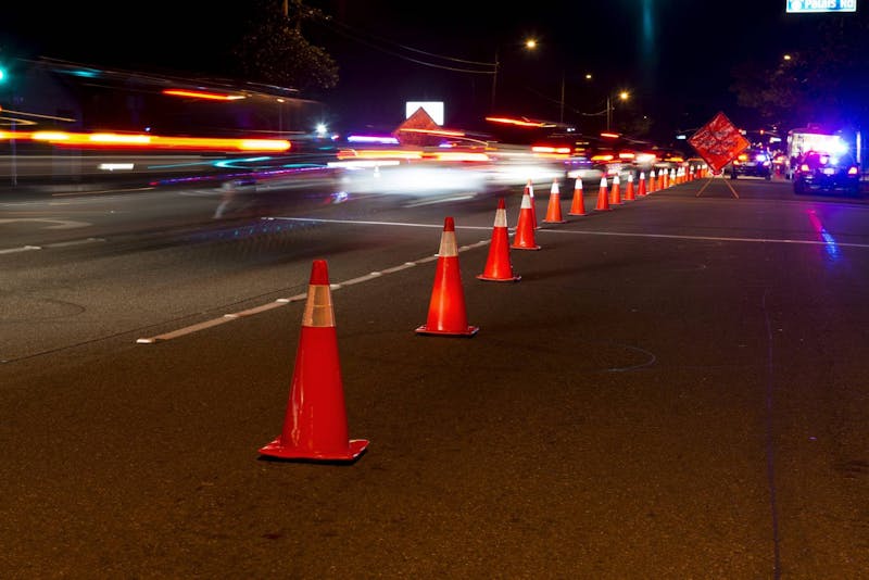 Cones lined up in the street directing traffic.