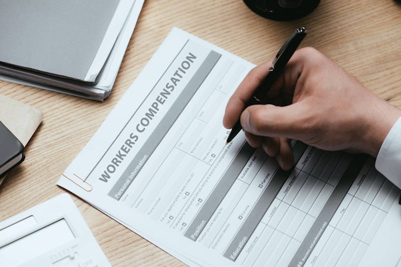 Man filling out workers' comp form.