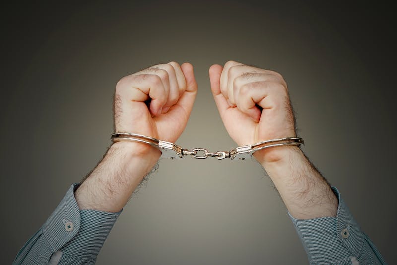 Closeup of a man with handcuffs on.