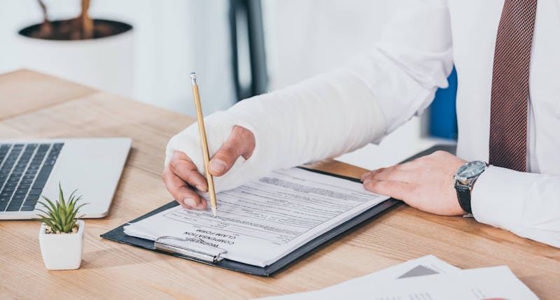 Injured person filling out a form.