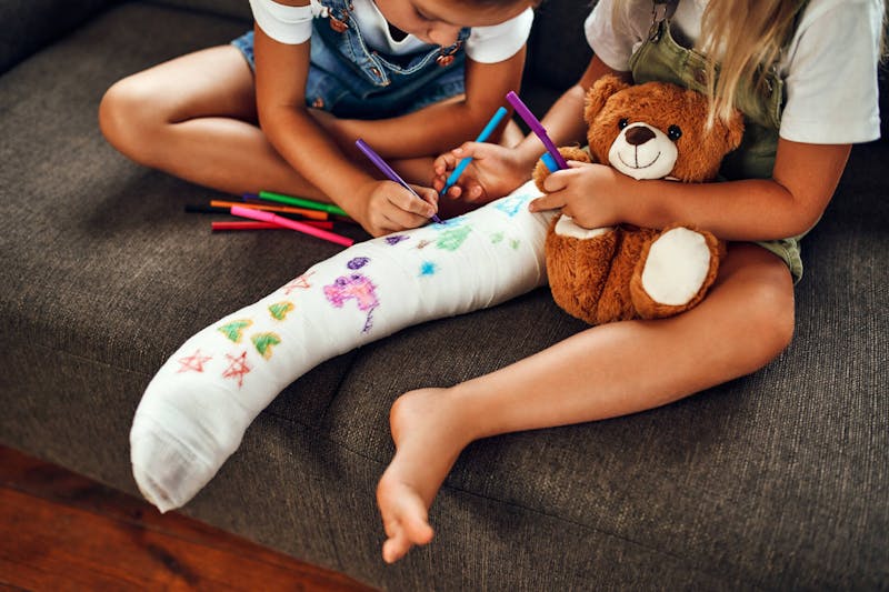 Children writing on cast